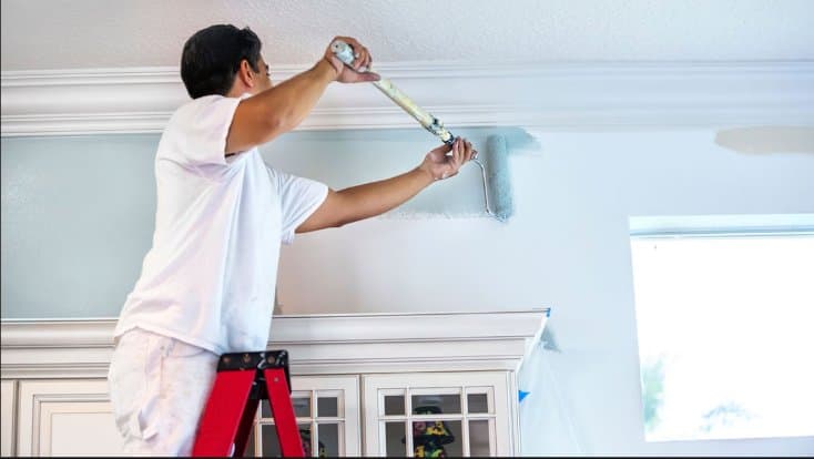 Acres Painting crew member rolling fresh paint in a Montgomery County home